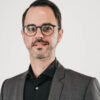 Managing Director Portrait with white background. Man wears a suit and looks frontally into the camera