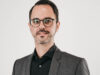 Managing Director Portrait with white background. Man wears a suit and looks frontally into the camera